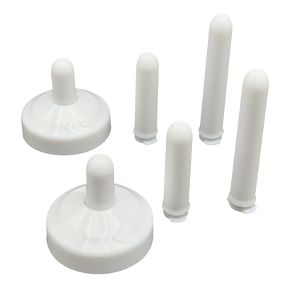 TidyCap with short bolt covers inserted and taller bolt covers standing next to toilet bolt caps