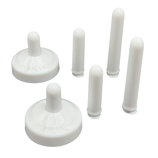 TidyCap with short bolt covers inserted and taller bolt covers standing next to toilet bolt caps